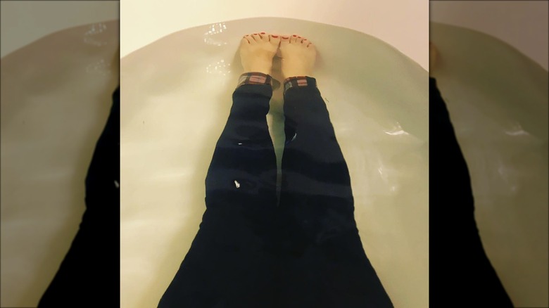 Women in the tub wearing jeans
