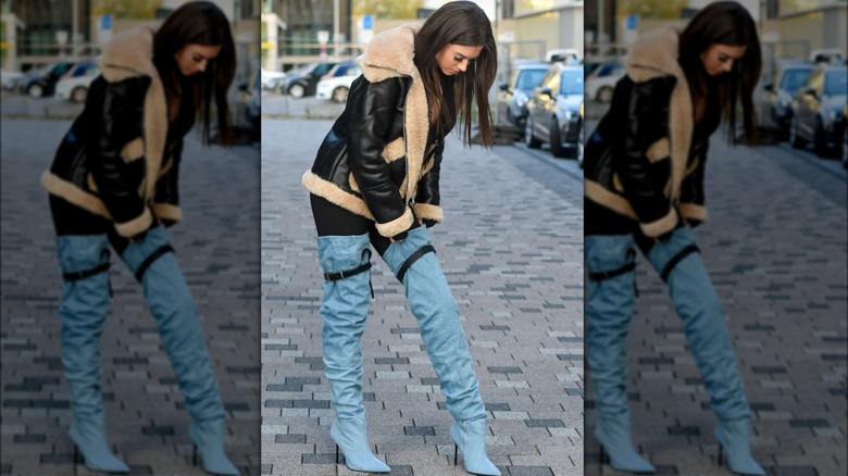 A woman wearing denim boots 