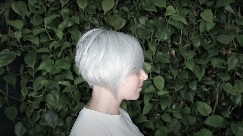 Side view of a woman with a grey asymmetrical bob