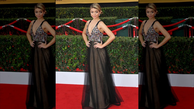 Sarah Hyland in a long and sheer black gown on the red carpet