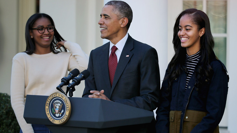 Sasha and Malia Obama with their father