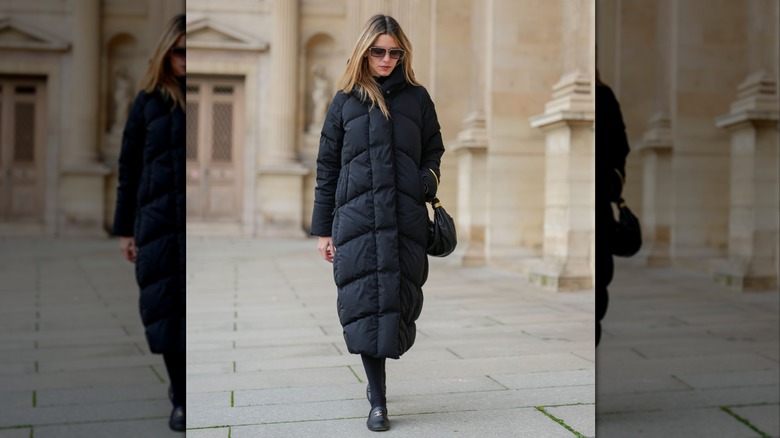 Woman wearing a red puffy coat in the snow