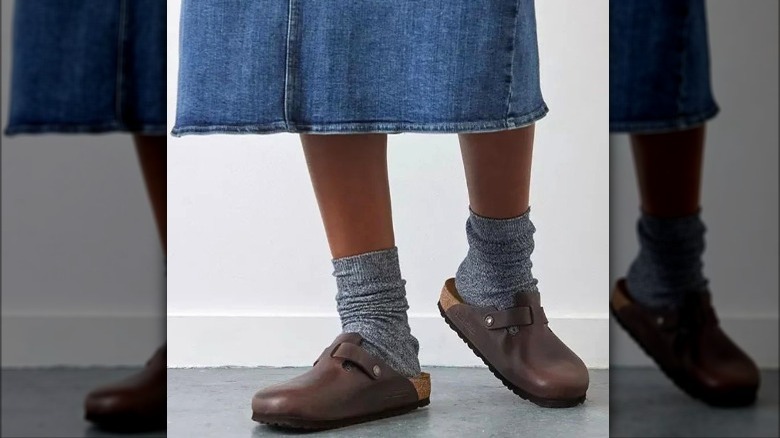 Model wearing denim skirt, mules and socks