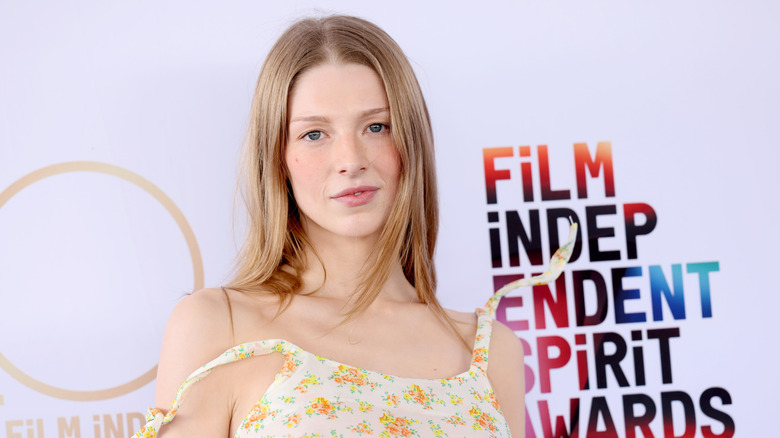 Hunter Schafer posing in a sun dress at a film festival