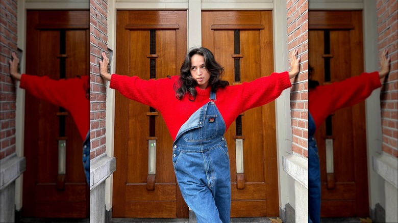 Woman in overalls and a red sweater