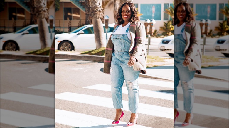 Woman in overalls and a blazer