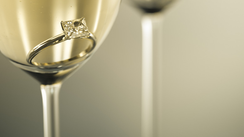 engagement ring in champagne glass