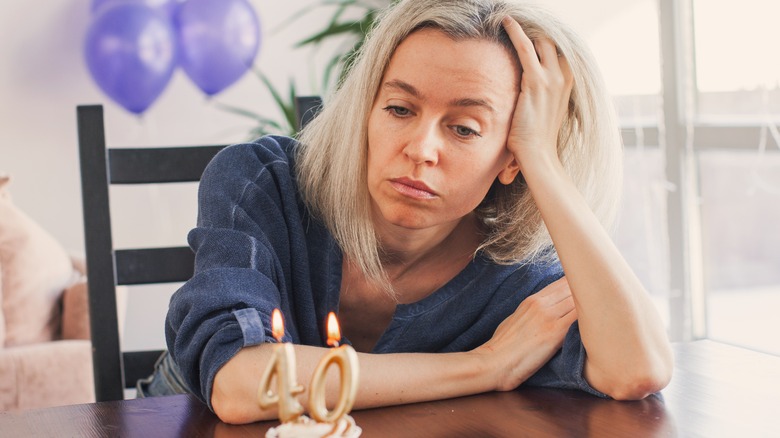 Woman looking glum at a party 