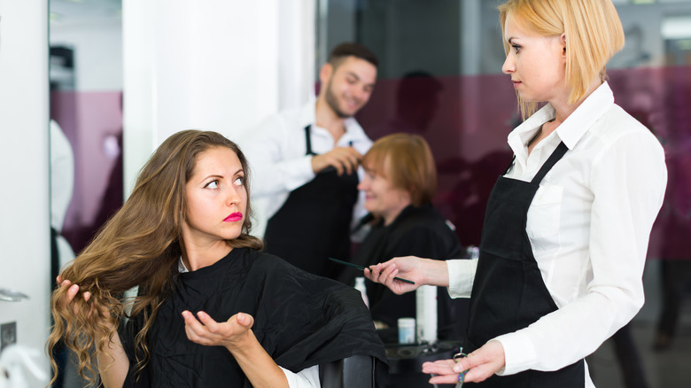 A woman disagreeing with her hairdresser
