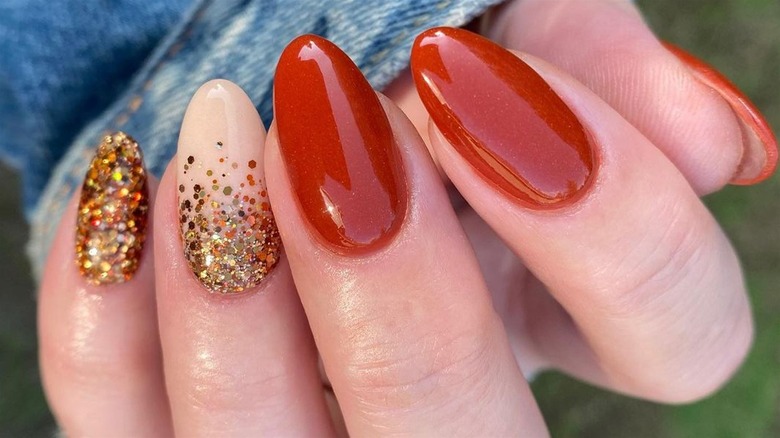 Orange glitter manicure