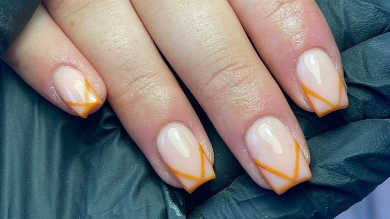 Nude and orange manicure