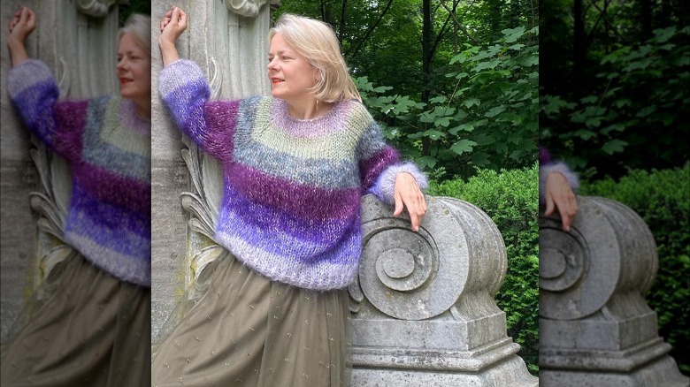 Woman modeling striped knit sweater