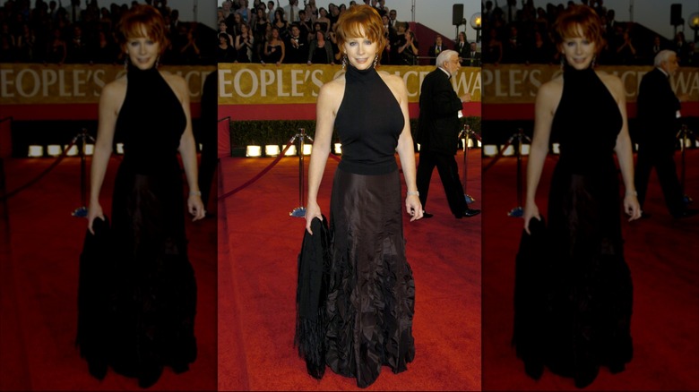 Reba McEntire wearing a black turtleneck and floor-length skirt with rouching in 2004