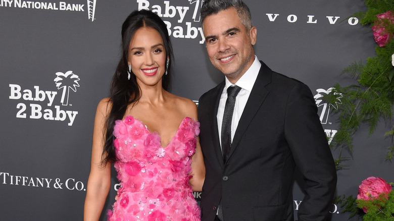 Jessica Alba in pink and Cash Warren in a suit at an event