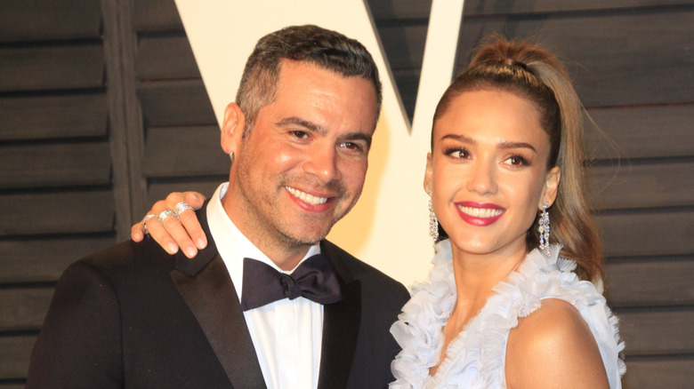 Jessica Alba in pale blue and Cash Warren in a suit at an event