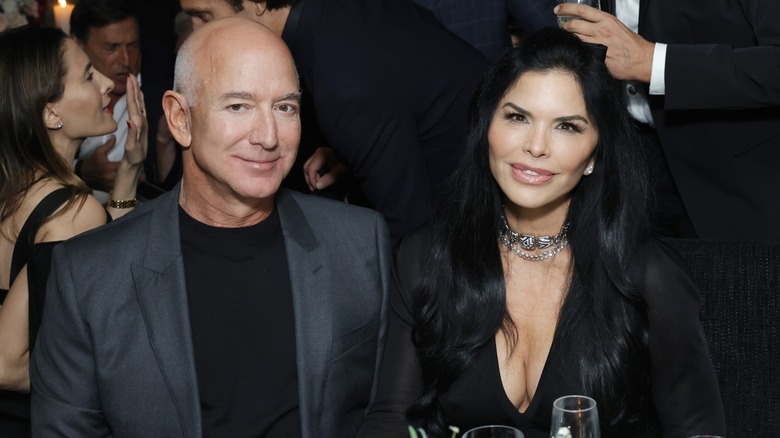 Jeff Bezos sitting at a table with Lauren Sanchez