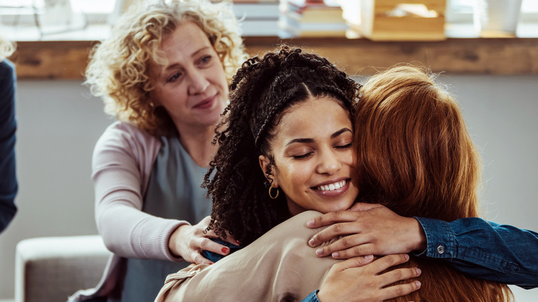 Woman being comforted by friends
