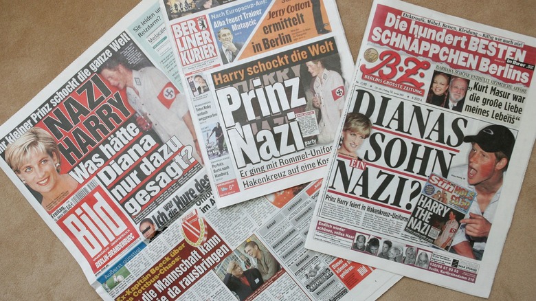 Newspapers detailing Prince Harry's Nazi costume