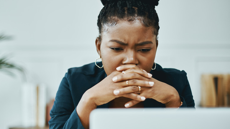 Concerned woman on laptop