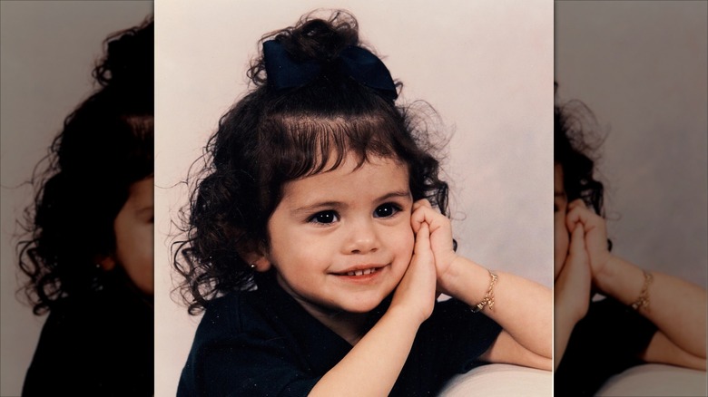 Selena Gomez as a child smiling in a pose