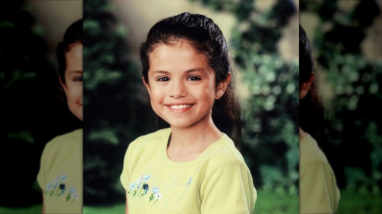 Selena Gomez as a young girl smiling