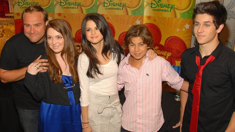 Selena Gomez posing with her Wizards of Waverly Place co-stars