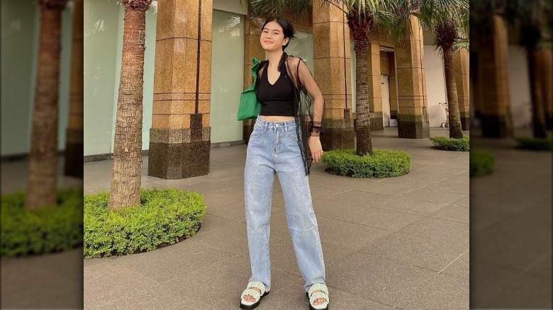 Febrianti Chanidra poses in baggy jeans and chunky sandals