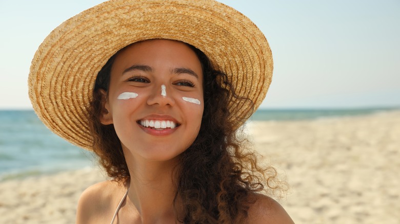 Woman at the beach wearing sunscreen