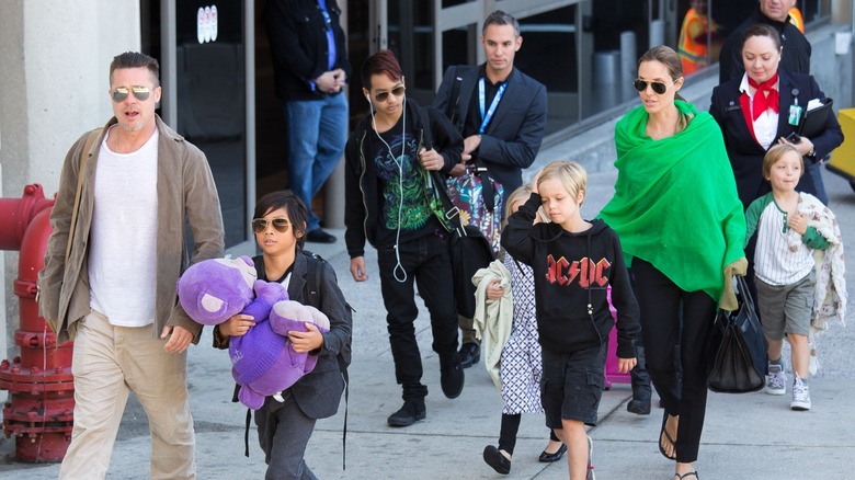 The Jolie-Pitt family carrying toys