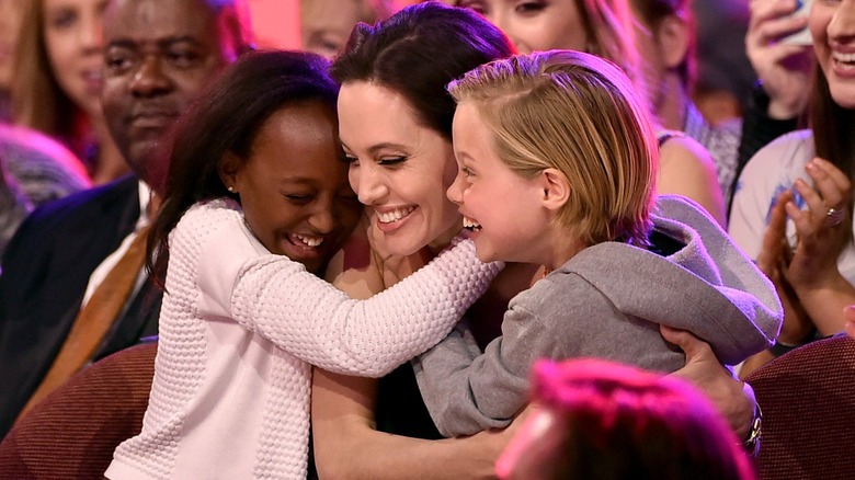 Shiloh Jolie hugging Angelina Jolie and Zahara Jolie