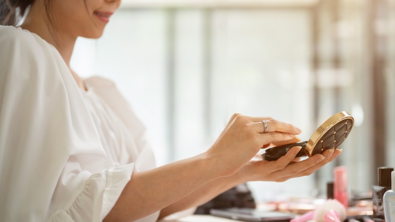 Person holding pressed powder