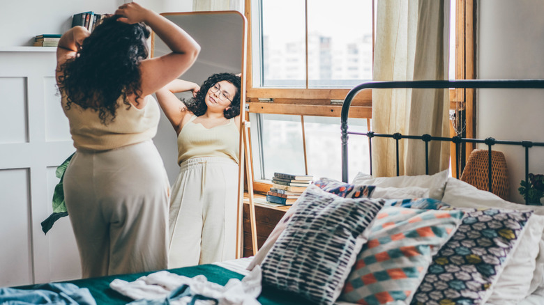 Woman admiring herself in the mirror