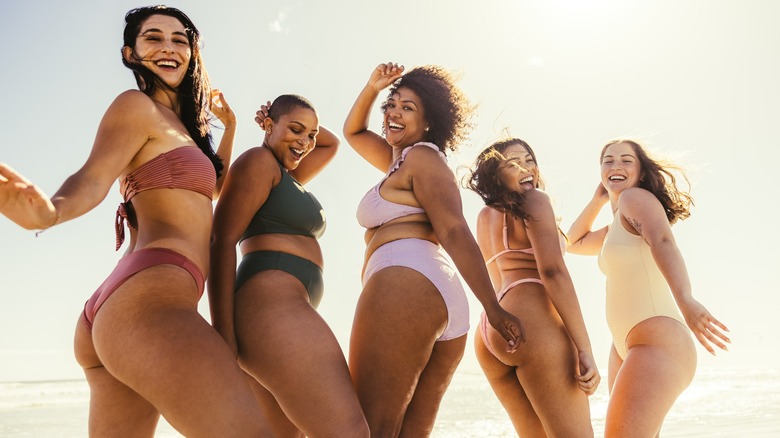 Women in bathing suits on beach 