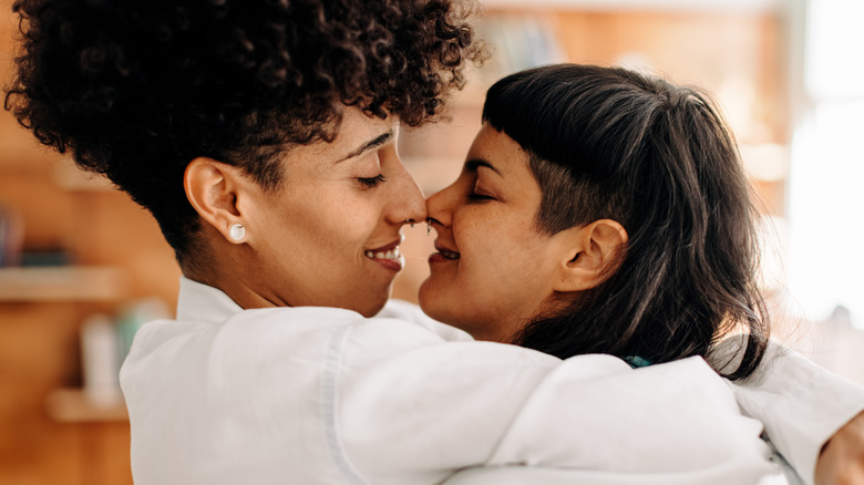 Two women intimately embracing and kissing