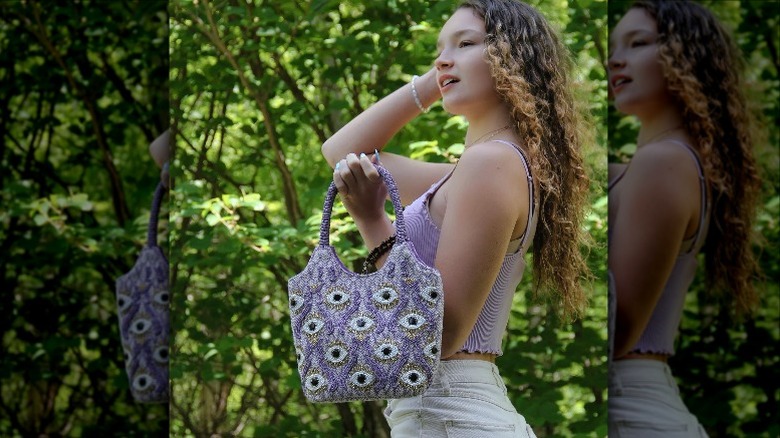 Person holding lavender purse