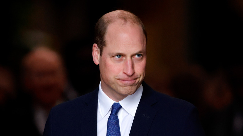 Prince William making a grimace in a suit