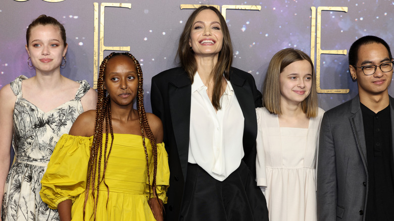 Shiloh standing with siblings and mother Angelina Jolie on red carpet