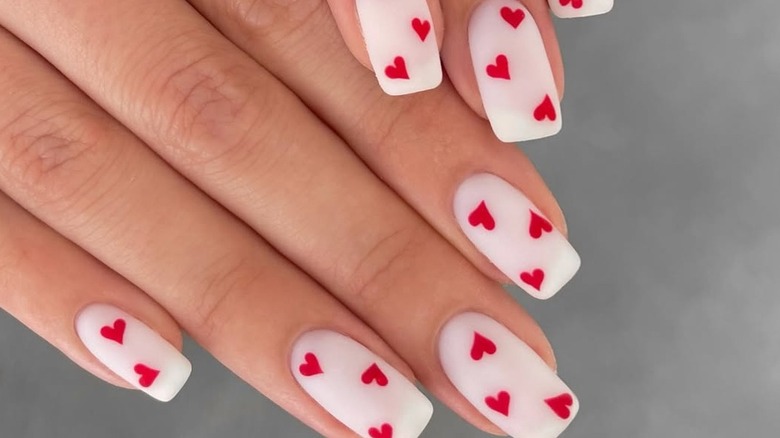 Matte milky white nails with red hearts