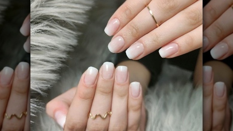 hands with nude manicure and rings
