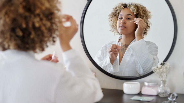 Woman applying serum 