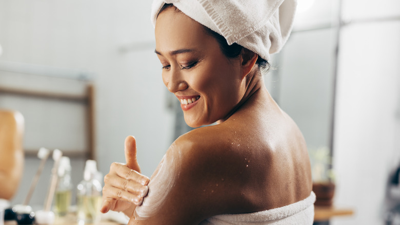 Woman applying sunscreen 