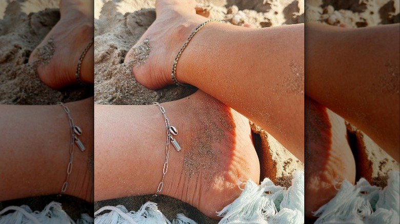 feet in sand wearing anklets