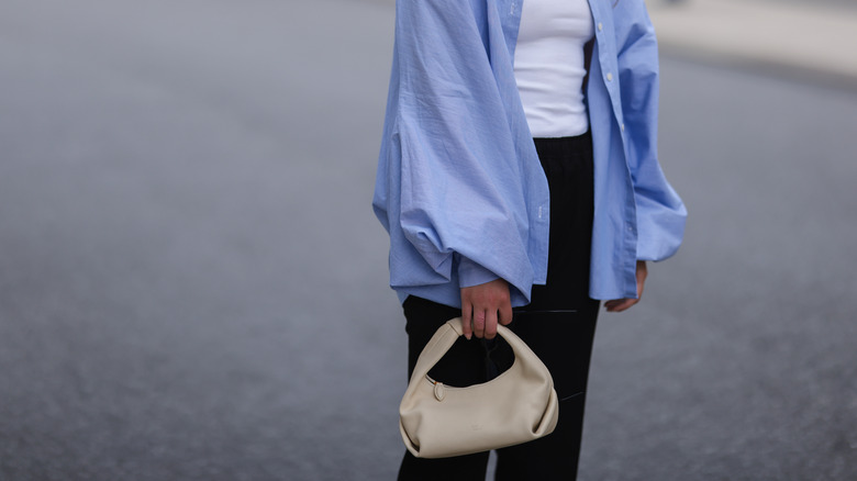 Woman with cream understated purse