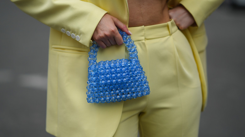 Yellow suit and small beaded bag