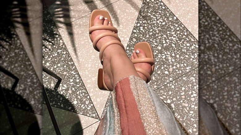 Woman wearing nude strappy sandals