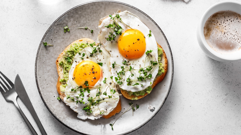 Eggs and greens spread on toast