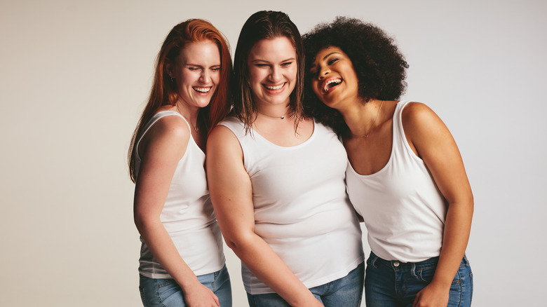 Three women in white tank tops