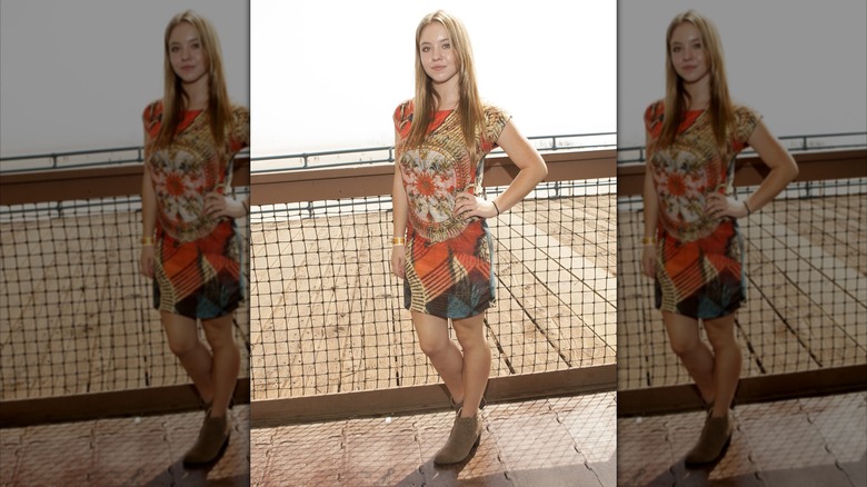 Sydney Sweeney in boots and a dress