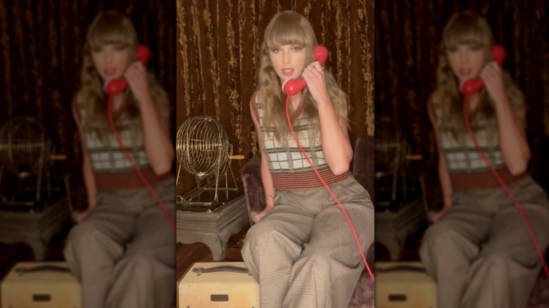 Taylor Swift in a TikTok still wearing a plaid sweater vest