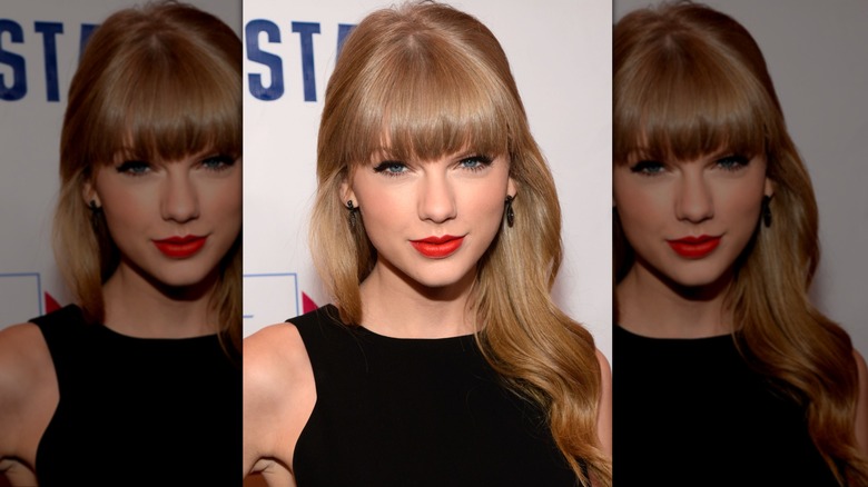 Taylor Swift giving a small smile with blunt bangs